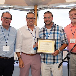 West Side Care Center's Patrick Neagle accepts scholarship award on behalf of Diana Orellana-Bolanos